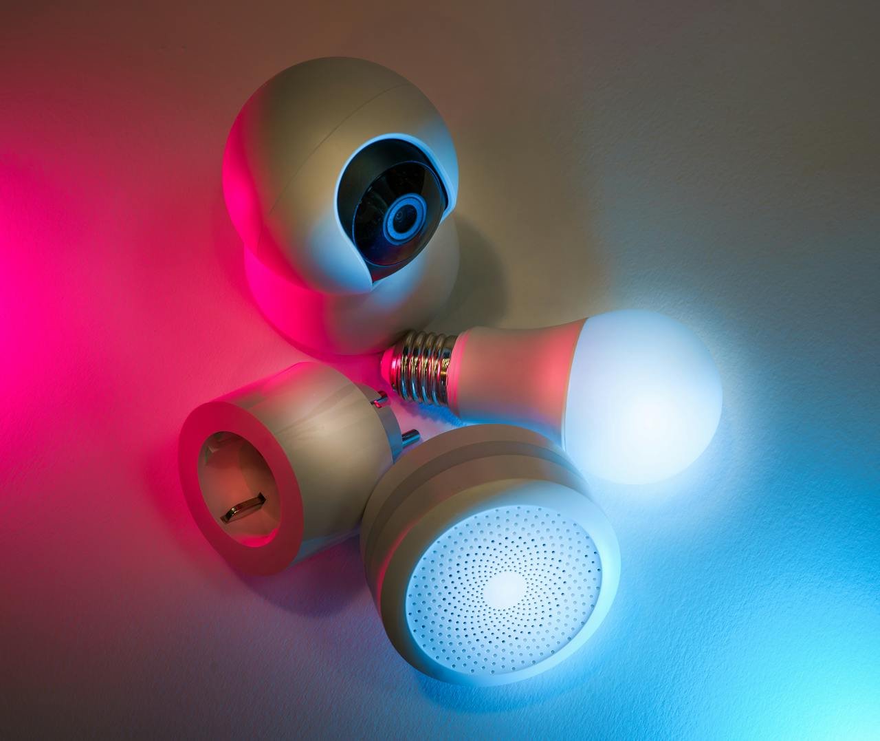 Smart home devices including camera, sensor, and bulb with ambient neon lighting. Ideal for tech concepts.